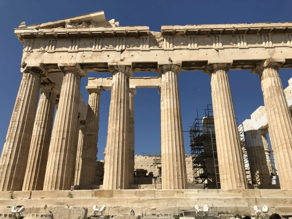 The stone columns of the Parthenon against a blue sky