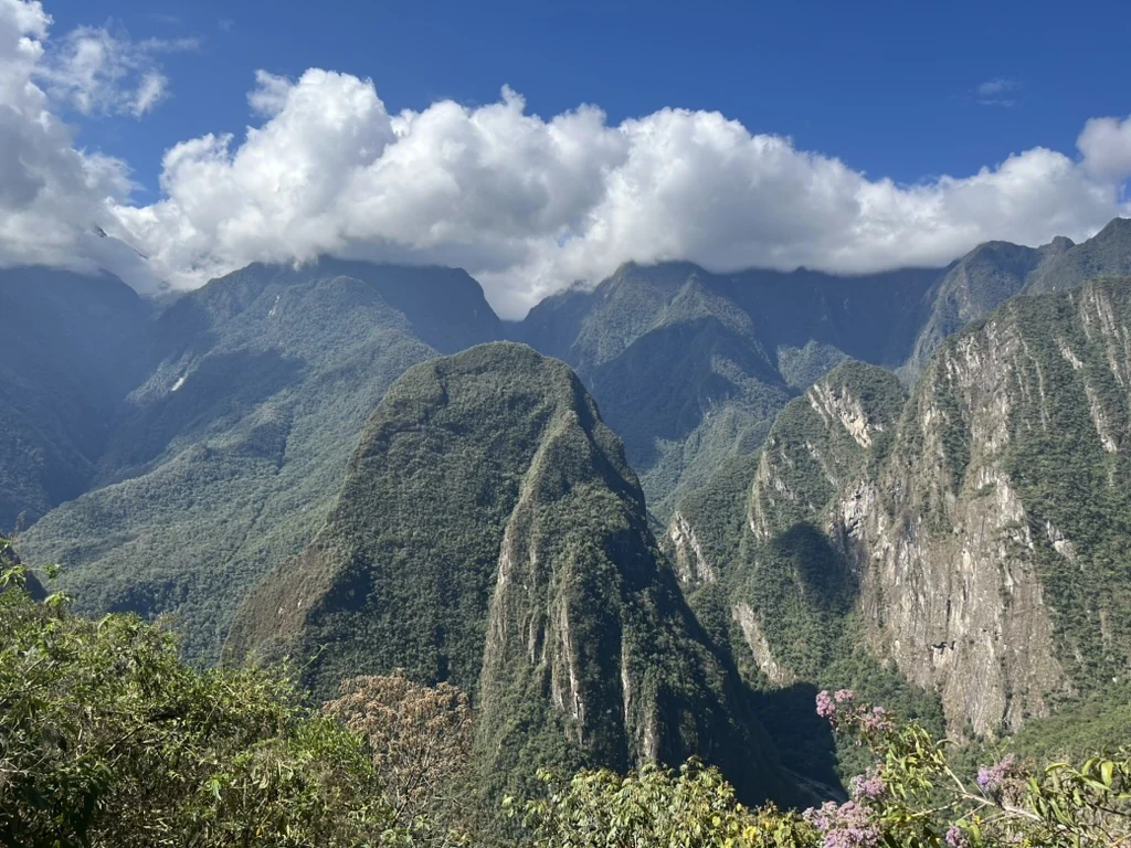 Clouds above the steep green mountain ridges of the Andes